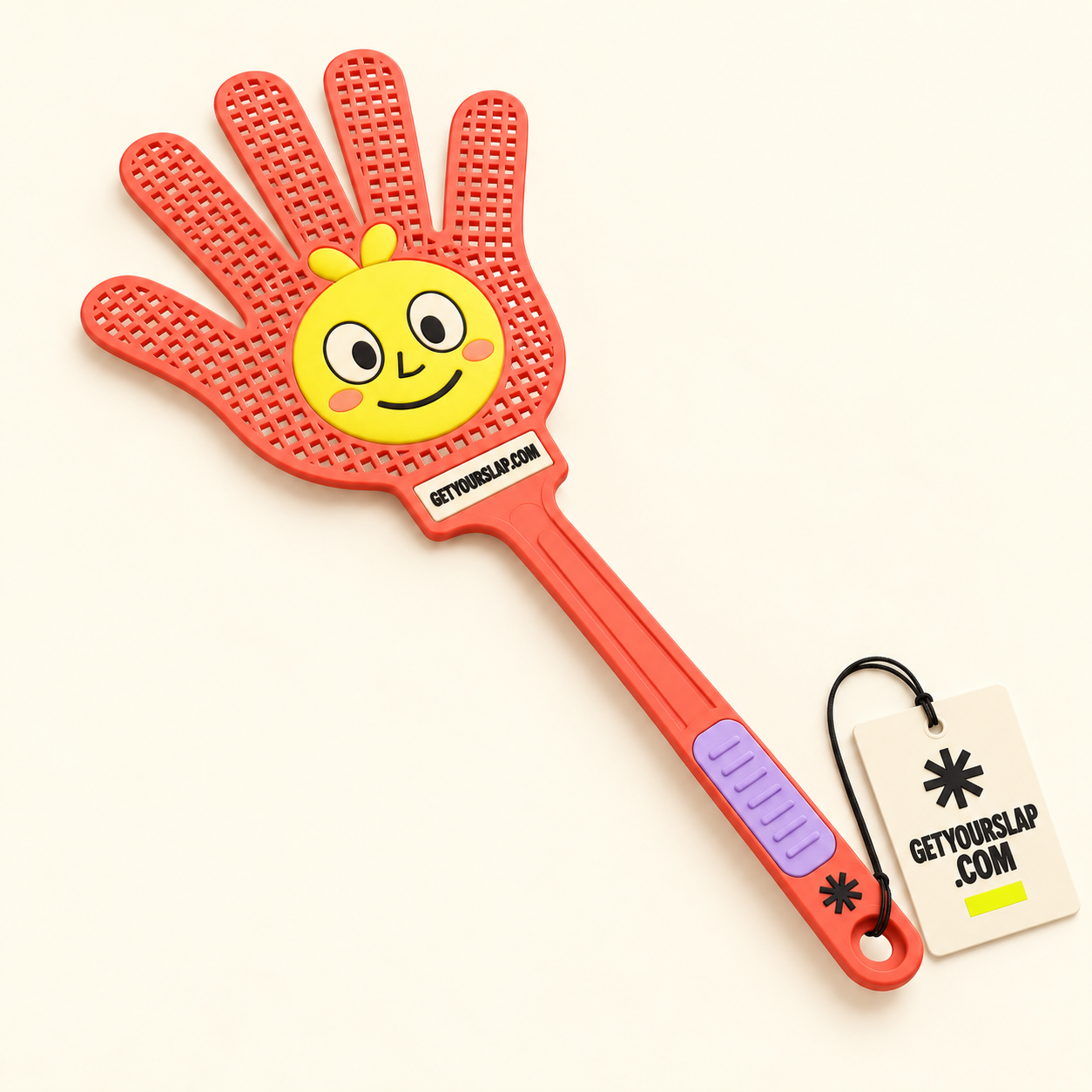 Coral hand-shaped fly swatter with our yellow mascot in its palm, a lilac grip, GETYOURSLAP.COM branding and an attached brand hangtag